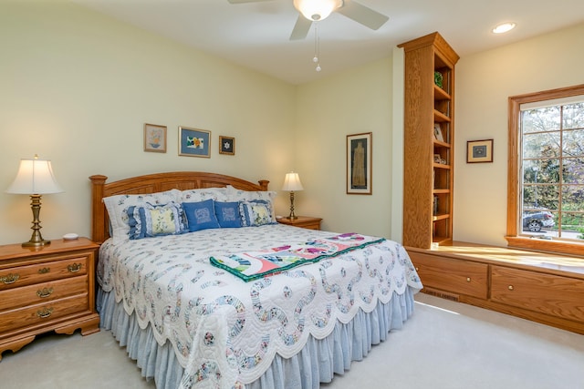 bedroom with light carpet and ceiling fan