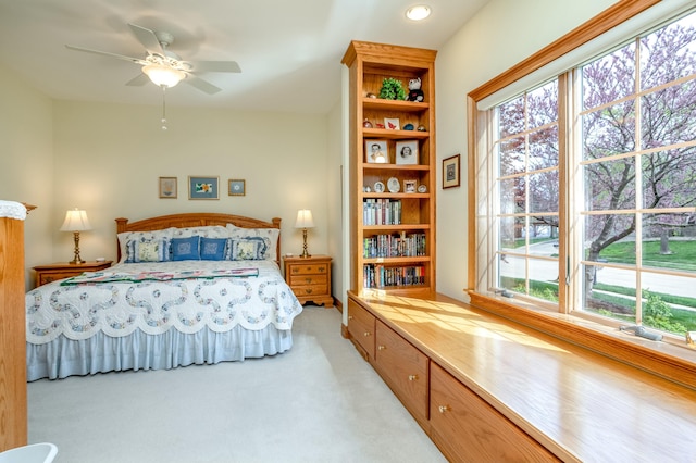 bedroom with light colored carpet, a ceiling fan, and recessed lighting
