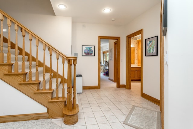 stairway with baseboards, tile patterned flooring, and recessed lighting