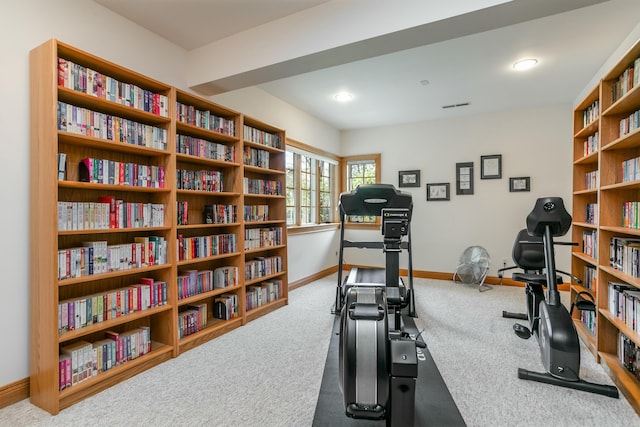 workout area featuring carpet flooring and baseboards