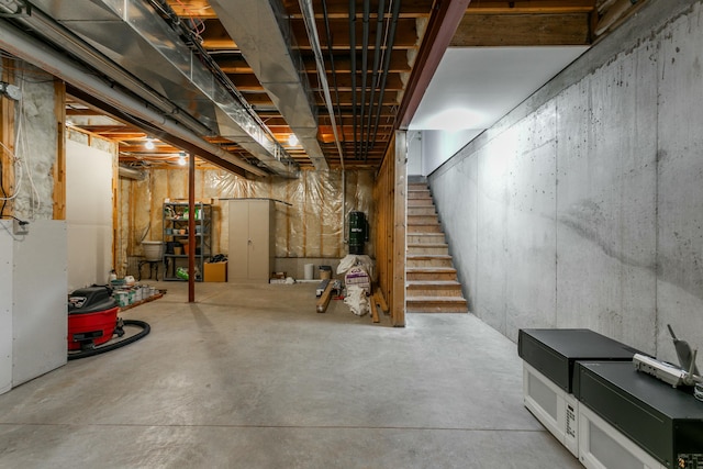 unfinished basement featuring stairs
