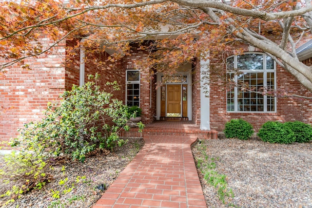 doorway to property featuring brick siding