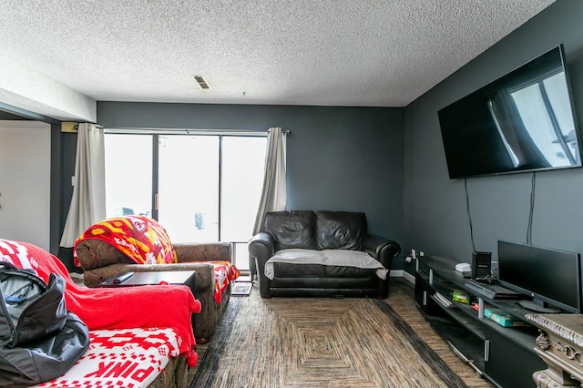 living area with a textured ceiling