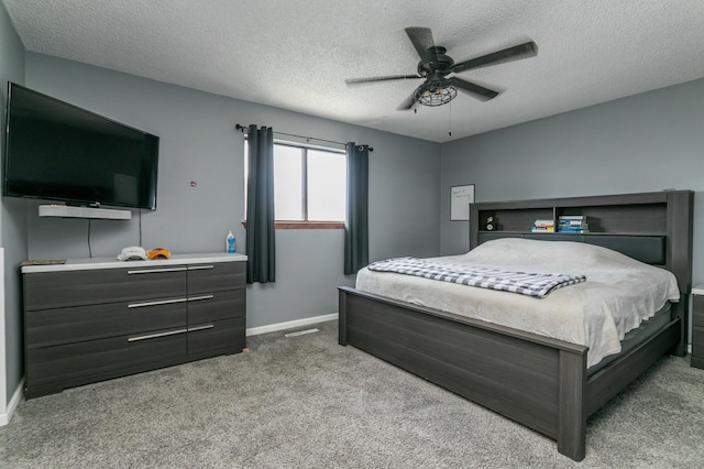 bedroom with baseboards, carpet floors, a textured ceiling, and ceiling fan