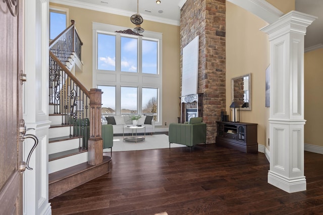 3207 Rivington Dr, Columbia, MO 65203 - foyer entrance featuring decorative columns, hardwood / wood-style floors, plenty of natural light, ornamental molding, and a high ceiling
