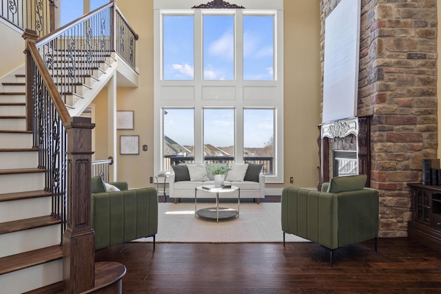 3207 Rivington Dr, Columbia, MO 65203 - living area featuring a high ceiling, hardwood / wood-style floors, a fireplace, and stairs