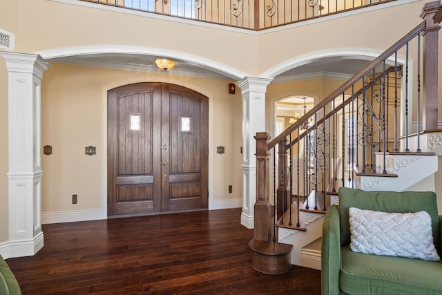 3207 Rivington Dr, Columbia, MO 65203 - foyer featuring arched walkways, hardwood / wood-style floors, ornate columns, baseboards, and a high ceiling