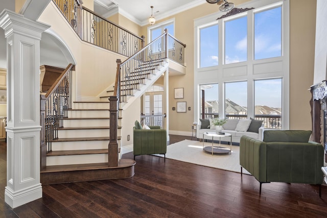 3207 Rivington Dr, Columbia, MO 65203 - living area featuring wood-type flooring, ornate columns, a high ceiling, healthy amount of natural light, and baseboards