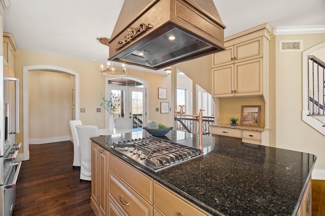 3207 Rivington Dr, Columbia, MO 65203 - kitchen with appliances with stainless steel finishes, arched walkways, cream cabinetry, custom exhaust hood, and dark wood-style floors