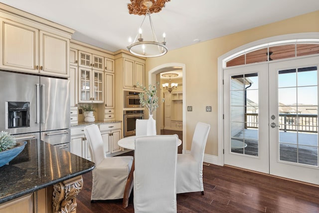 3207 Rivington Dr, Columbia, MO 65203 - dining room with a chandelier, dark wood-style floors, french doors, baseboards, and arched walkways