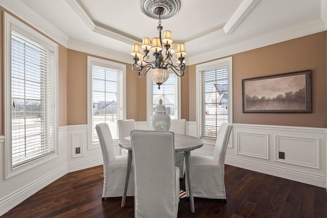 3207 Rivington Dr, Columbia, MO 65203 - dining room featuring a chandelier, wainscoting, dark wood-style flooring, a raised ceiling, and crown molding
