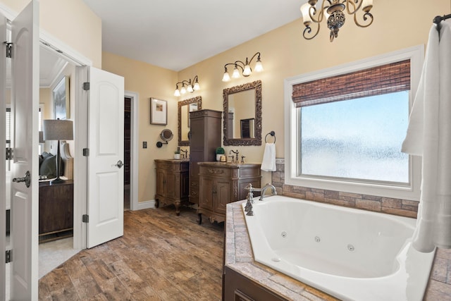 3207 Rivington Dr, Columbia, MO 65203 - ensuite bathroom with vanity, wood finished floors, a whirlpool tub, and a chandelier