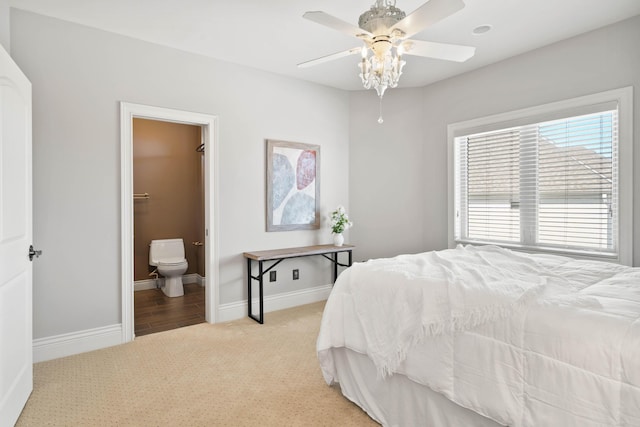 3207 Rivington Dr, Columbia, MO 65203 - bedroom with light carpet, baseboards, ensuite bathroom, and a ceiling fan