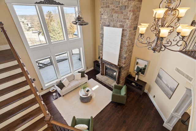 3207 Rivington Dr, Columbia, MO 65203 - living area with a glass covered fireplace, wood finished floors, a chandelier, baseboards, and stairs