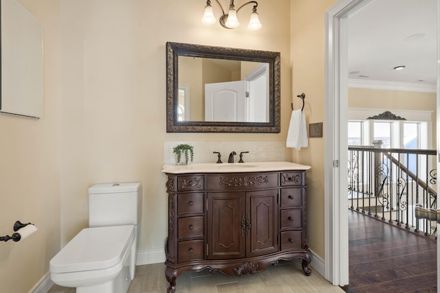 3207 Rivington Dr, Columbia, MO 65203 - bathroom featuring baseboards, toilet, tasteful backsplash, vanity, and ornamental molding