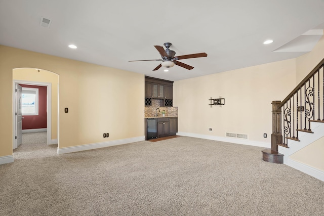 3207 Rivington Dr, Columbia, MO 65203 - unfurnished living room featuring bar with sink, ceiling fan, light carpet, baseboards, and recessed lighting