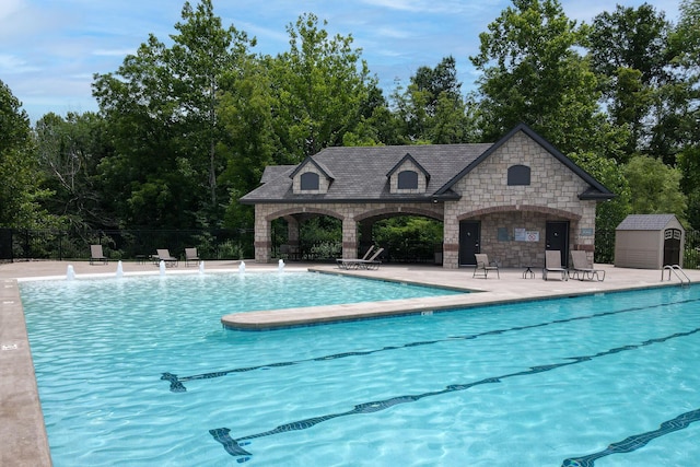3207 Rivington Dr, Columbia, MO 65203 - community pool with fence, an outdoor structure, a patio area, and a storage unit