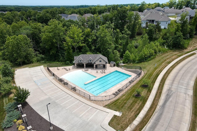 3207 Rivington Dr, Columbia, MO 65203 - community pool featuring a patio, fence, an outbuilding, and a wooded view