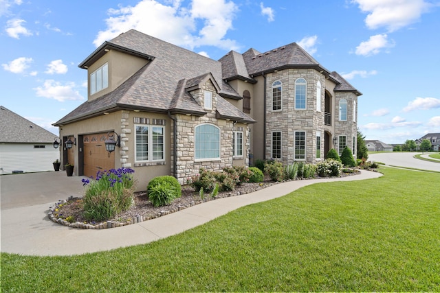 3207 Rivington Dr, Columbia, MO 65203 - french country home with stone siding, a front lawn, a garage, driveway, and stucco siding