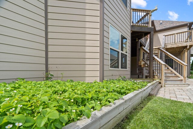 3207 Rivington Dr, Columbia, MO 65203 - view of side of property with a vegetable garden, stairway, and a wooden deck