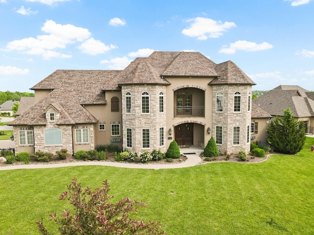 3207 Rivington Dr, Columbia, MO 65203 - french country style house with stone siding, stucco siding, a balcony, and a front lawn