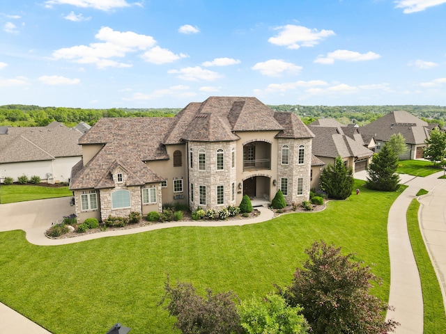 3207 Rivington Dr, Columbia, MO 65203 - french provincial home with stone siding, a balcony, stucco siding, and a front yard