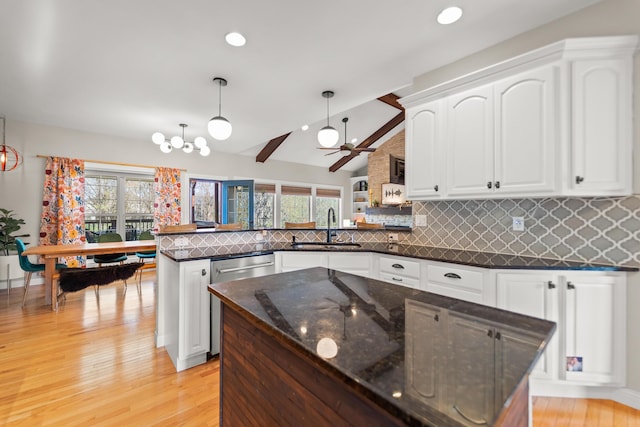 5109 Newbury Way, Columbia, MO 65203 - kitchen with dishwasher, a sink, a peninsula, white cabinetry, and decorative backsplash