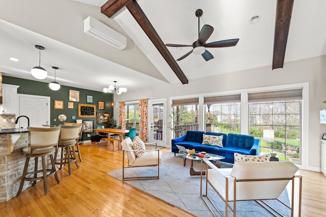 5109 Newbury Way, Columbia, MO 65203 - living room featuring light wood-style floors, ceiling fan with notable chandelier, a wall mounted air conditioner, and a healthy amount of sunlight