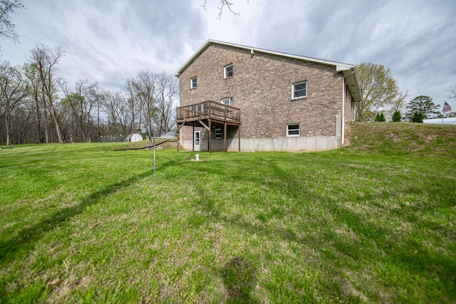 back of property with a lawn and a deck