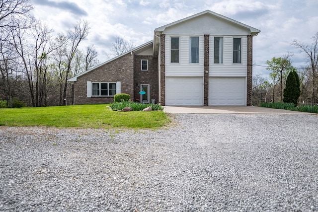 view of front of property with brick siding, an attached garage, driveway, and a front yard