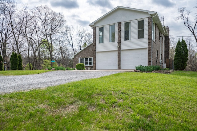 exterior space with brick siding, a yard, an attached garage, and gravel driveway