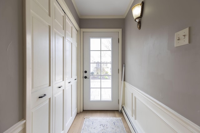 30 Holman Rd, Moberly, MO 65270 - entryway with light wood finished floors, a baseboard radiator, crown molding, and a wainscoted wall