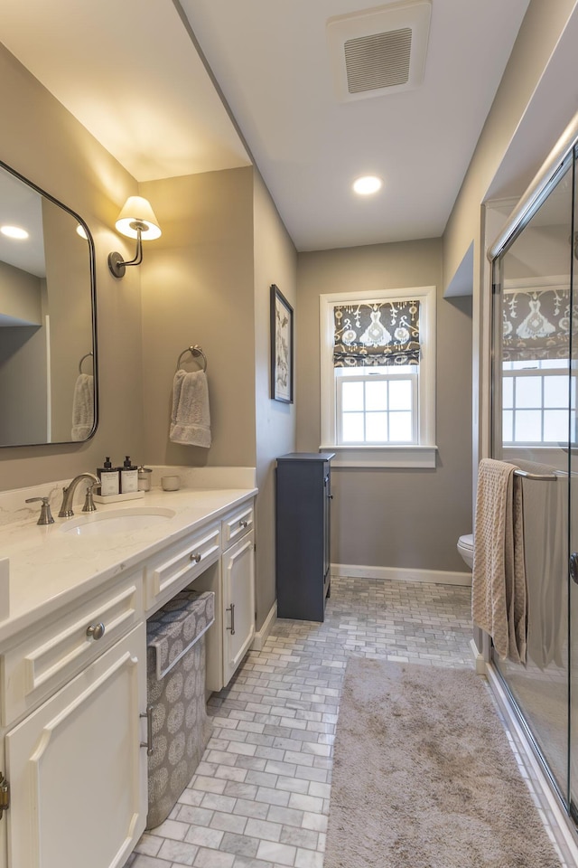 30 Holman Rd, Moberly, MO 65270 - full bath featuring vanity, baseboards, a stall shower, toilet, and visible vents