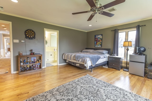 30 Holman Rd, Moberly, MO 65270 - bedroom with crown molding, wood finished floors, and freestanding refrigerator