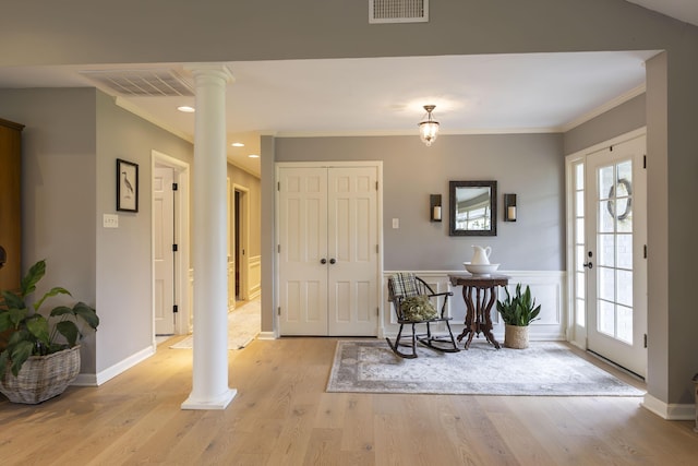 30 Holman Rd, Moberly, MO 65270 - foyer entrance featuring light wood-type flooring, decorative columns, visible vents, and plenty of natural light