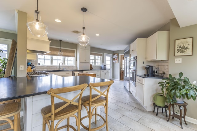 30 Holman Rd, Moberly, MO 65270 - kitchen with a peninsula, a sink, backsplash, and dark countertops