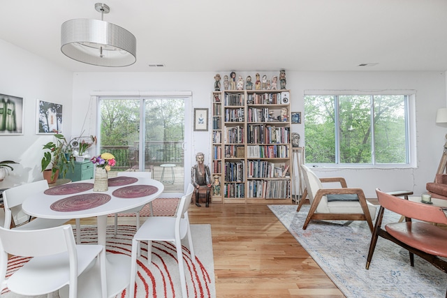dining space featuring plenty of natural light and light wood-style floors