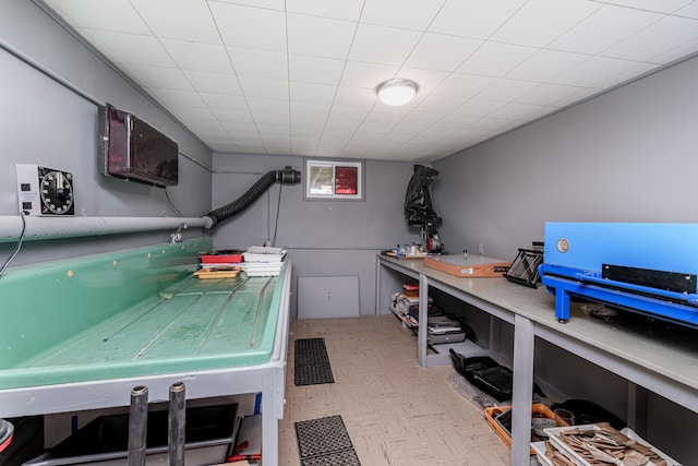 laundry room with tile patterned floors and a workshop area