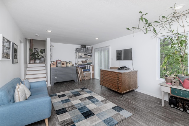 living room with dark wood-type flooring, baseboards, stairway, and recessed lighting