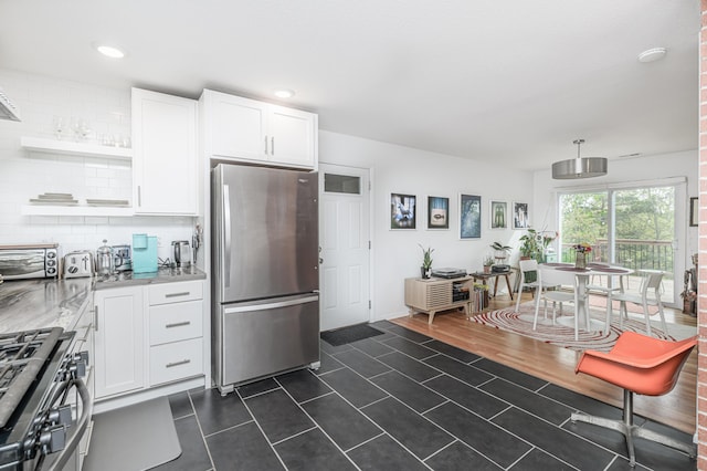 kitchen featuring appliances with stainless steel finishes, open shelves, dark tile patterned flooring, white cabinets, and light stone counters
