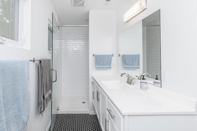 bathroom featuring a stall shower and vanity