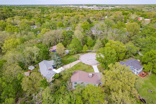 aerial view of property's location featuring a heavily wooded area