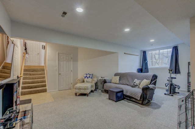 carpeted living area featuring stairway, baseboards, recessed lighting, and visible vents