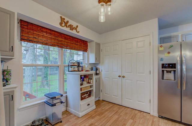 recreation room with light wood-type flooring and baseboards