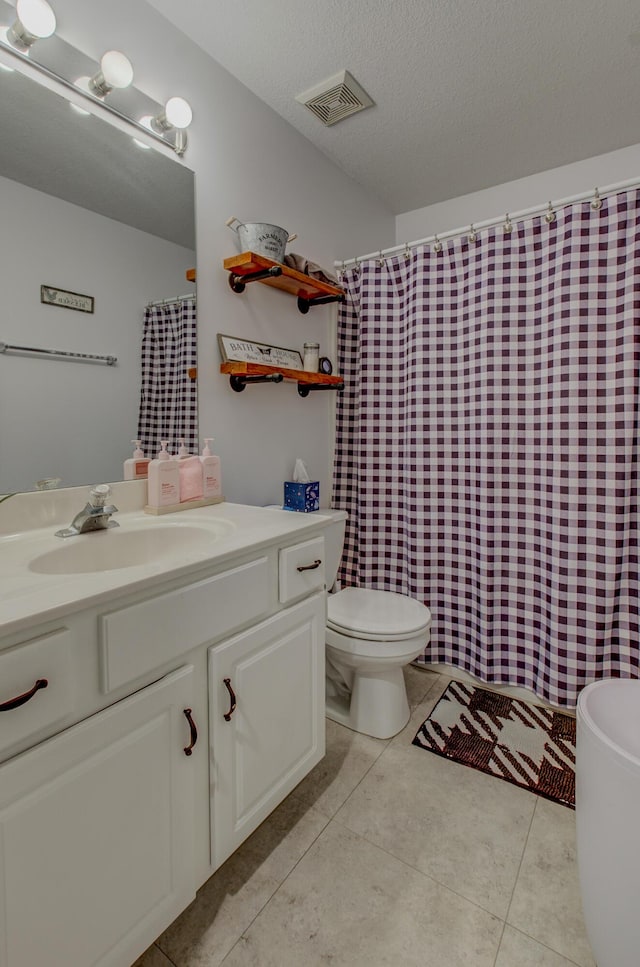 full bathroom featuring toilet, tile patterned floors, visible vents, and vanity