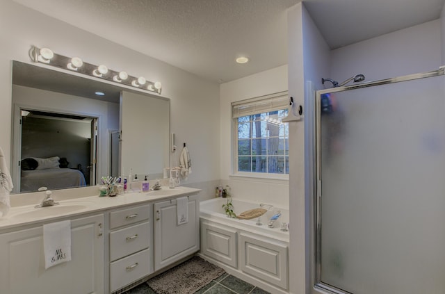 full bathroom with a sink, tile patterned flooring, ensuite bathroom, and a garden tub