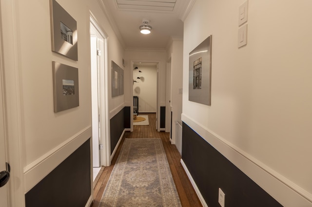 corridor with crown molding and dark wood finished floors