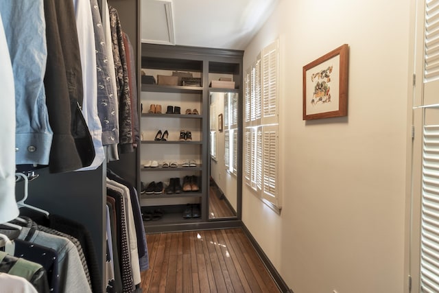 walk in closet featuring dark wood finished floors