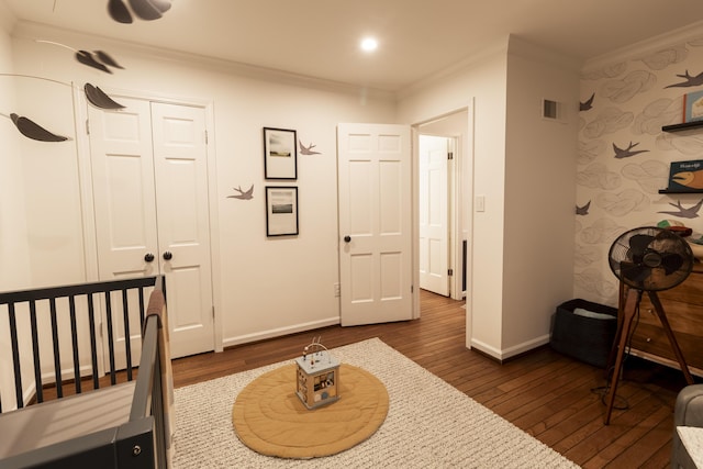 bedroom with dark wood-type flooring, ornamental molding, baseboards, and recessed lighting