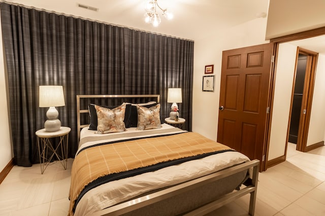 bedroom with tile patterned floors and baseboards